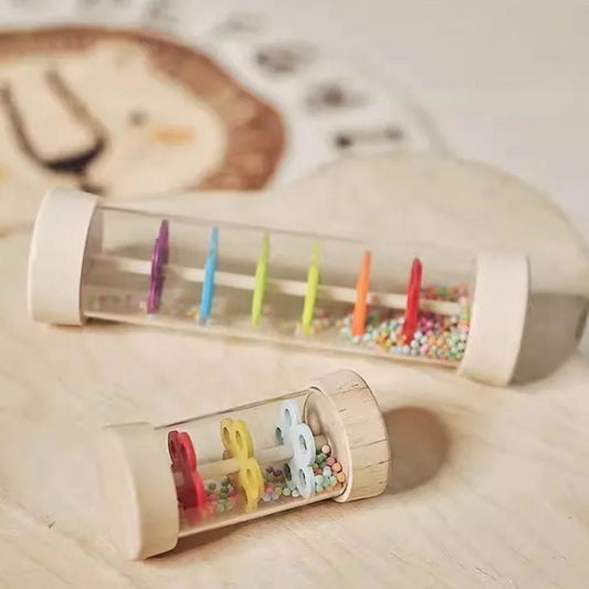 Two wooden toys with colorful pegs and beads on a light wooden surface.