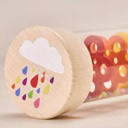 Wooden toy with colorful raindrop design and cloud on a beige background