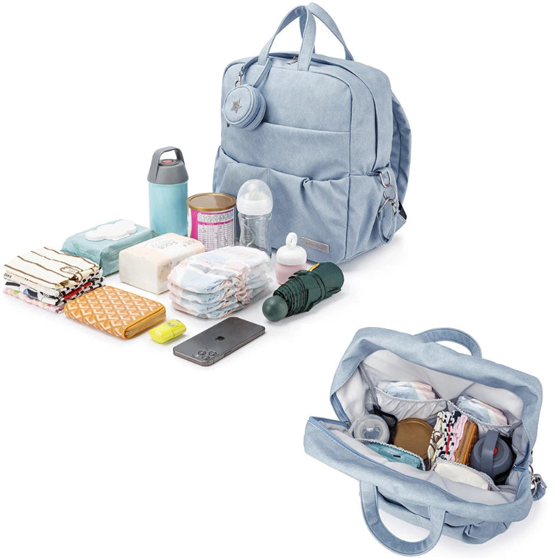 Light blue diaper bag with its contents displayed on a white background