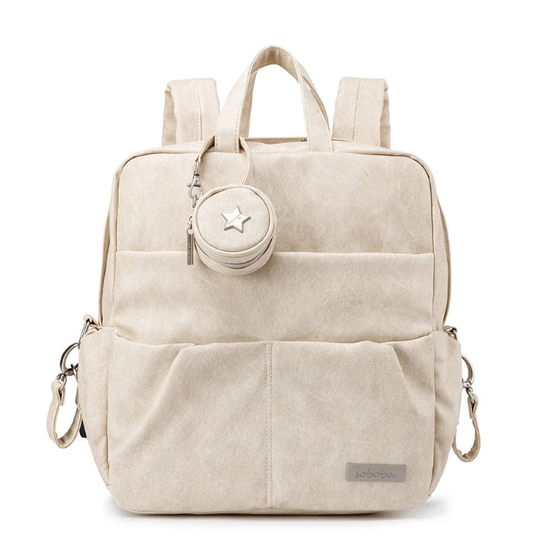 Beige backpack with a small round pouch attached on a white background