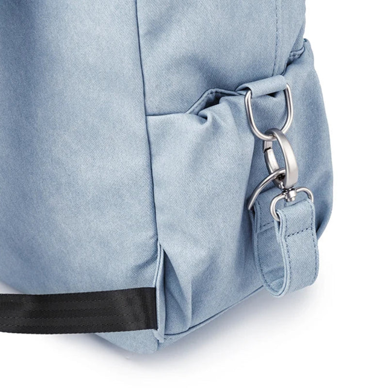 Light blue backpack with a keychain on a white background