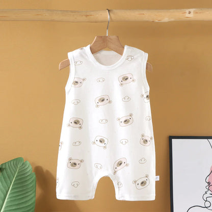 White baby romper with bear pattern on a hanger against a yellow wall.