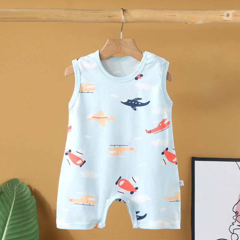 Baby romper with airplane pattern on a hanger against a yellow wall