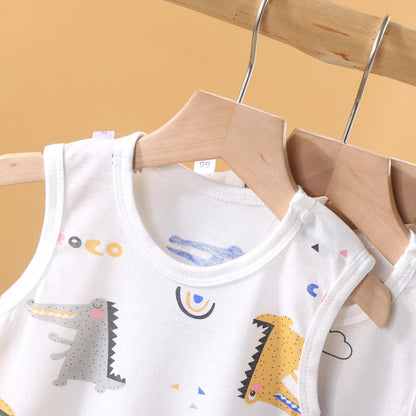 Children's bibs with cartoon designs on a wooden hanger against a yellow background