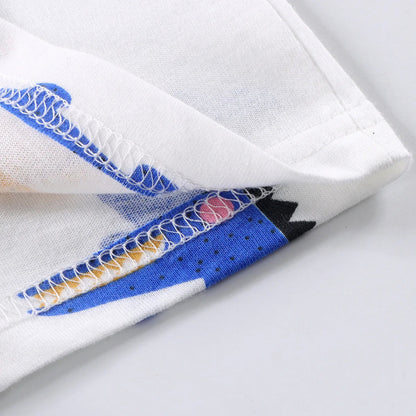 Close-up of white fabric with blue and multicolored pattern on a light gray background