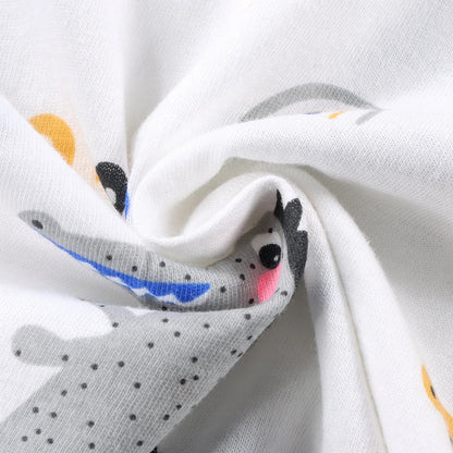 Close-up of a white fabric with cartoon shark designs.