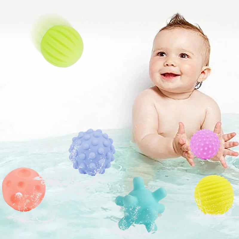 Baby playing with colorful bath toys in water
