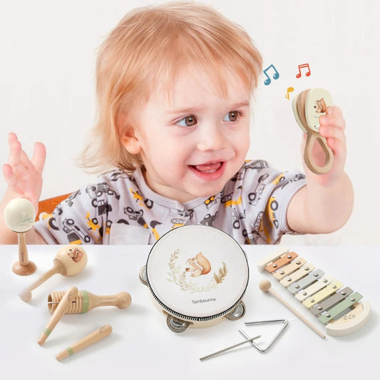 Child playing with musical instruments on a light background