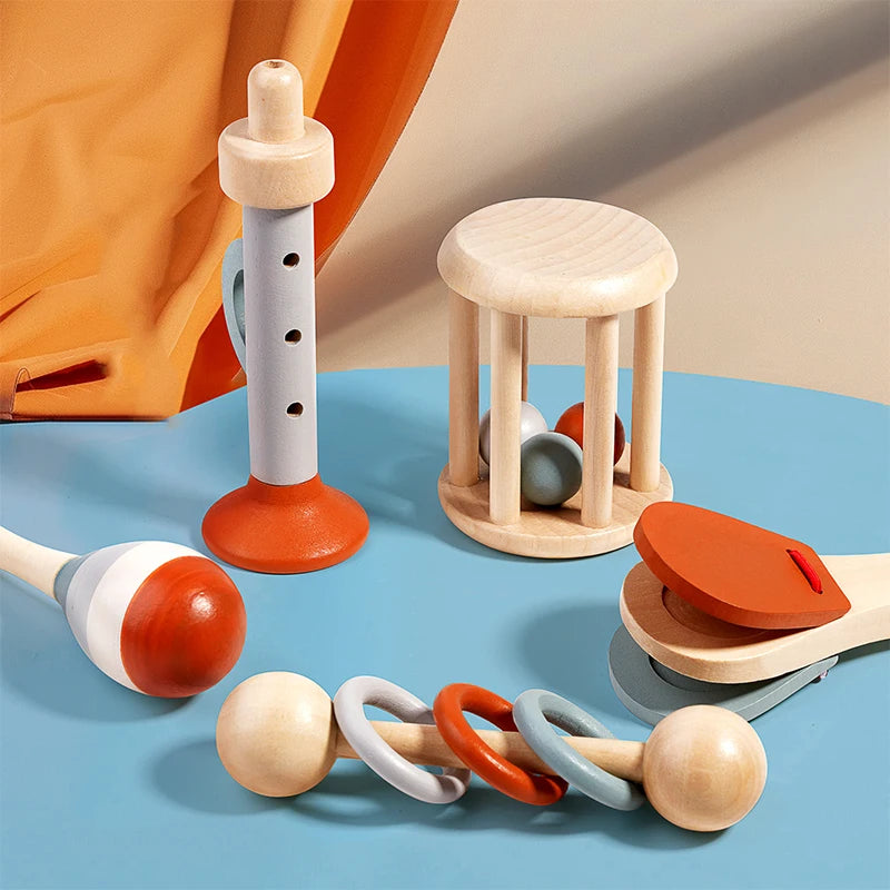Set of colorful wooden baby toys on a blue surface