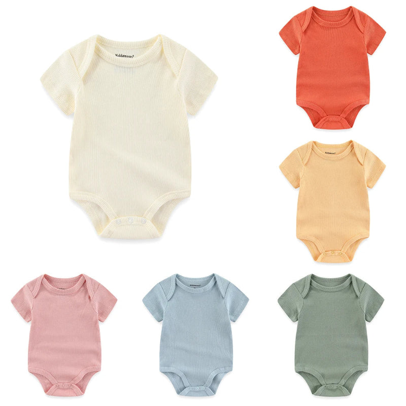 Set of six colorful baby bodysuits on a white background