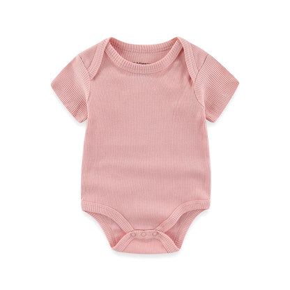 Pink baby bodysuit on a white background