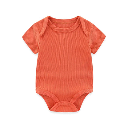Orange baby onesie on a white background