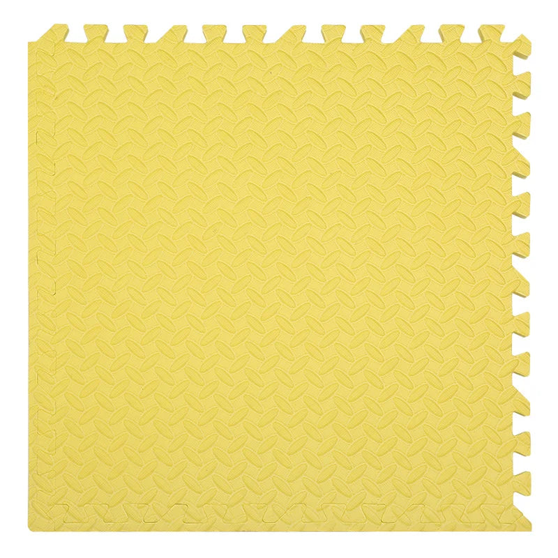 Yellow foam puzzle mat with interlocking edges on a white background
