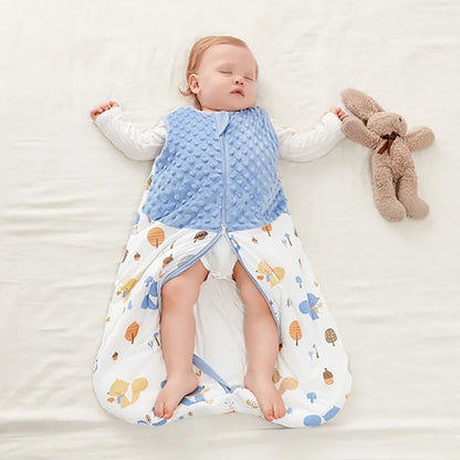 Baby sleeping in a patterned sleeping bag with a blue vest and a plush toy on a white background