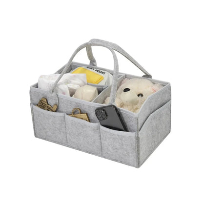 Gray caddy with compartments containing plush toys and a phone on a white background